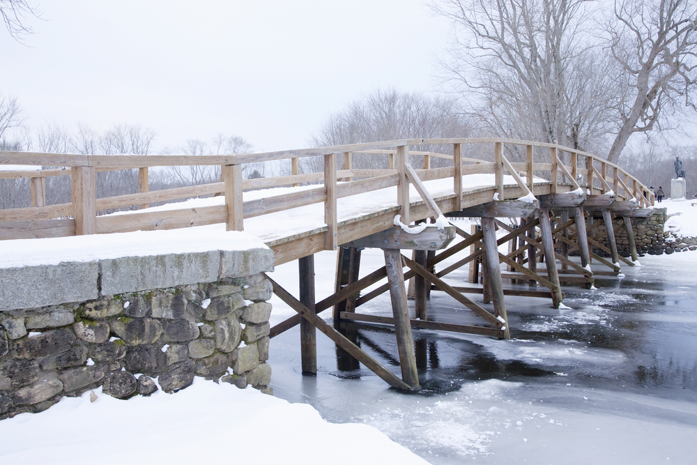 A snow covered bridge during the holiday season in Concord, MA.